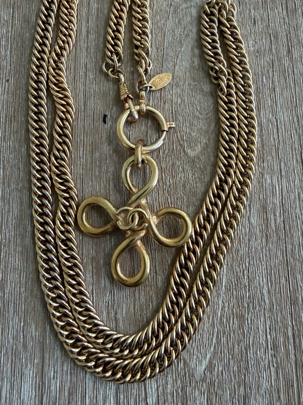 CHANEL Gold-Tone Multi-Strand Necklace with Knot Motif Pendant